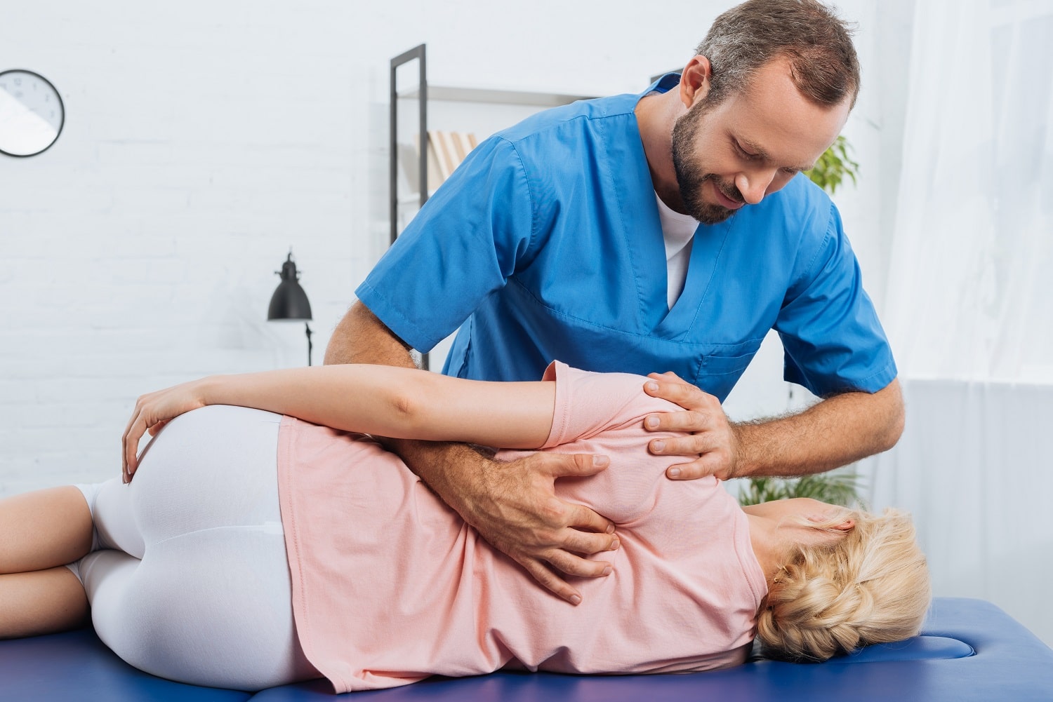 Physical therapist in Flint, Michigan performs shoulder mobilization on a patient, showcasing our clinic's expertise in shoulder pain treatment and recovery