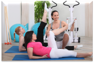 Girls doing physical exercise under the supervision of a trainer