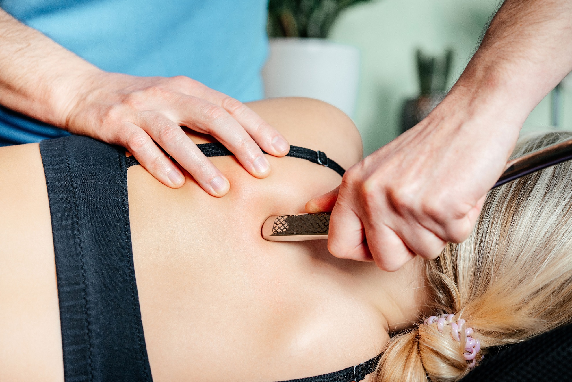Close-up view of the Graston Technique being applied to treat trigger finger, showcasing the precision of IASTM at our Flint, MI clinic