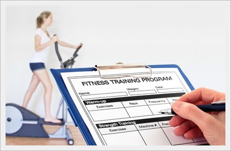 In the Gym - a fitness trainer completes a program for a client