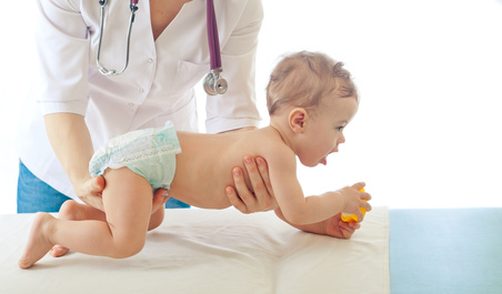 Pediatrician examining baby - doctor and patient