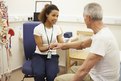 Physical therapist guiding a patient through strengthening exercises for recovery.