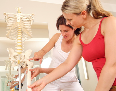 Therapist at Horizon PT Flint helping a patient with posture exercises for a healthy spine.