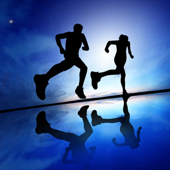 Silhouette of a woman running against the evening sky