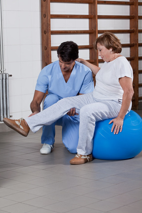 Male Physical therapist helping a patient.
