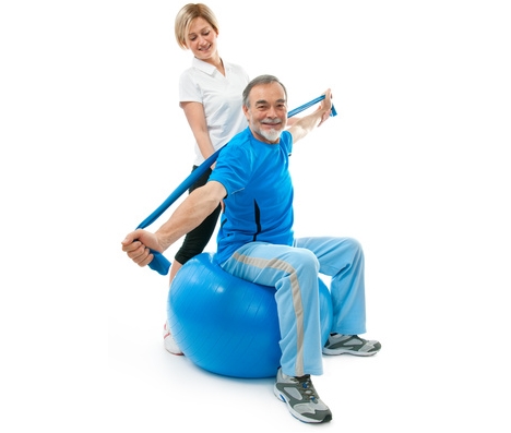 Senior man doing fitness exercise with help of trainer at sport gym