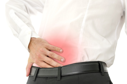 Individual in Flint experiencing lower back pain, indicating a potential lumbar spine issue
