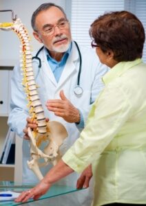 Doctor in Flint educating a patient on spine anatomy for better spinal health understanding