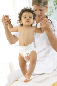 Physical therapist guiding a child patient through an exercise to improve strength and mobility at Horizon Physical Therapy
