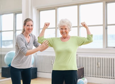 A physical therapist assisting a lupus patient with targeted exercises at Horizon Physical Therapy in Flint, Michigan.